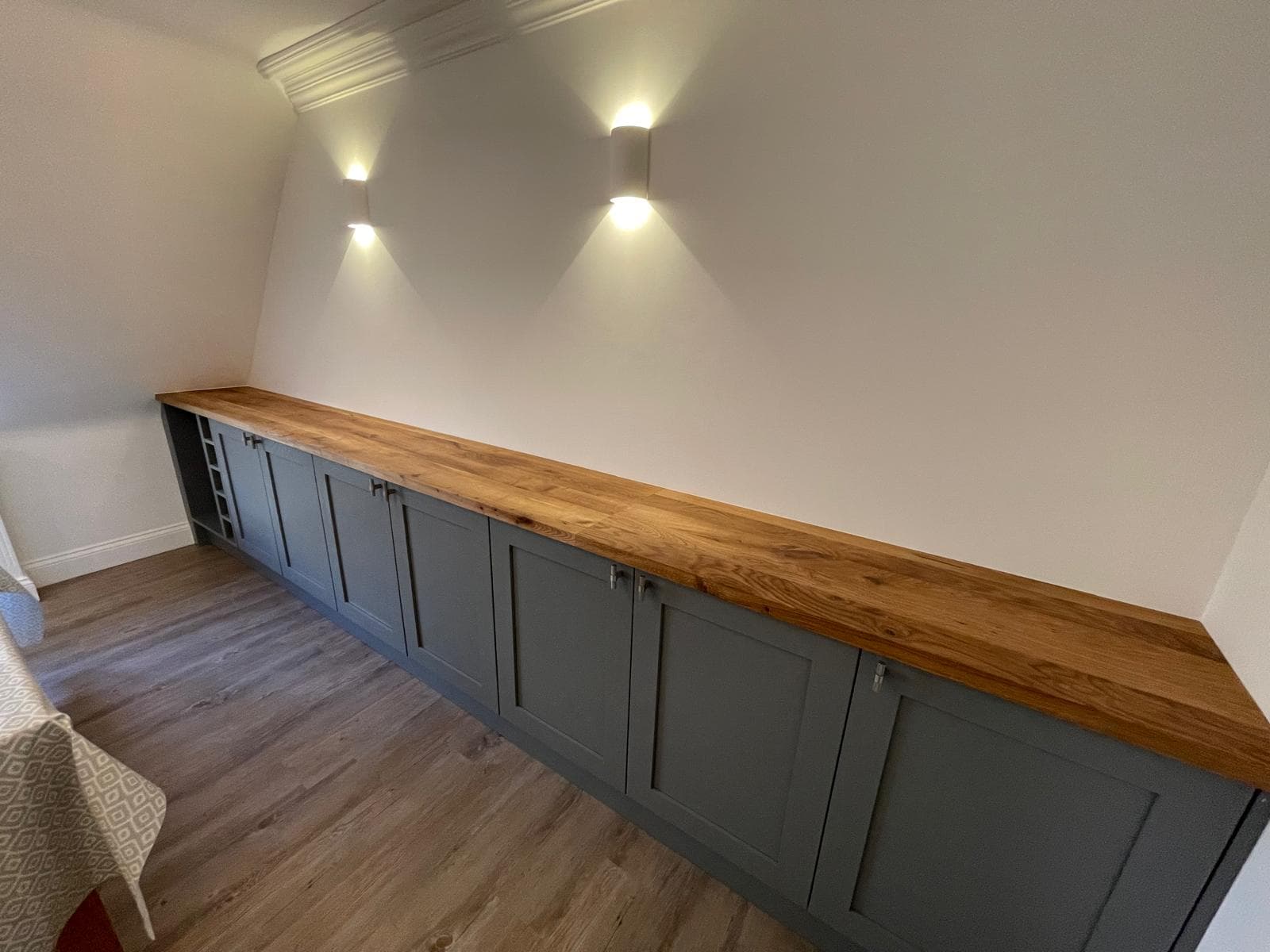 Fitted utility cabinetry in slate-blue with a solid oak worktop and integrated wine rack